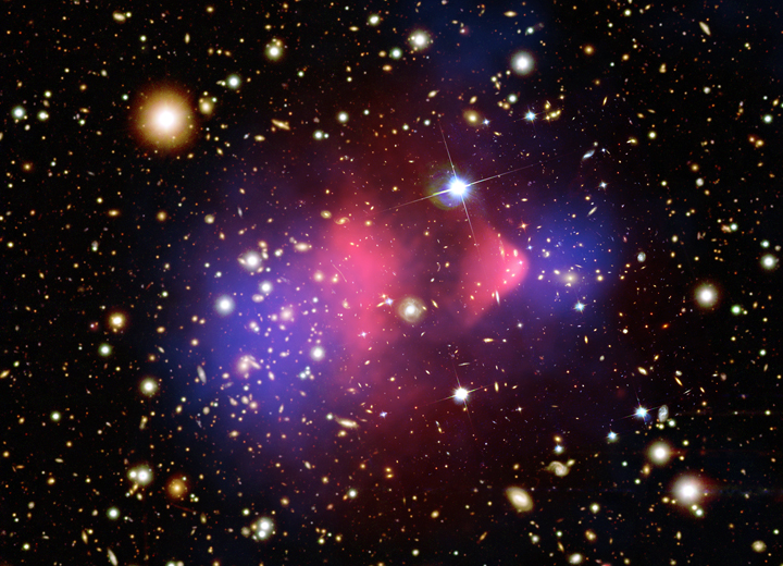 The Bullet Cluster, two colliding galaxy clusters, showing hot gas in pink separated from the bulk of the mass mapped in blue