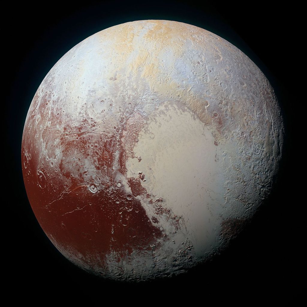 Pluto in enhanced color from New Horizons, showing the large pale heart-shaped nitrogen-ice plain Tombaugh Regio