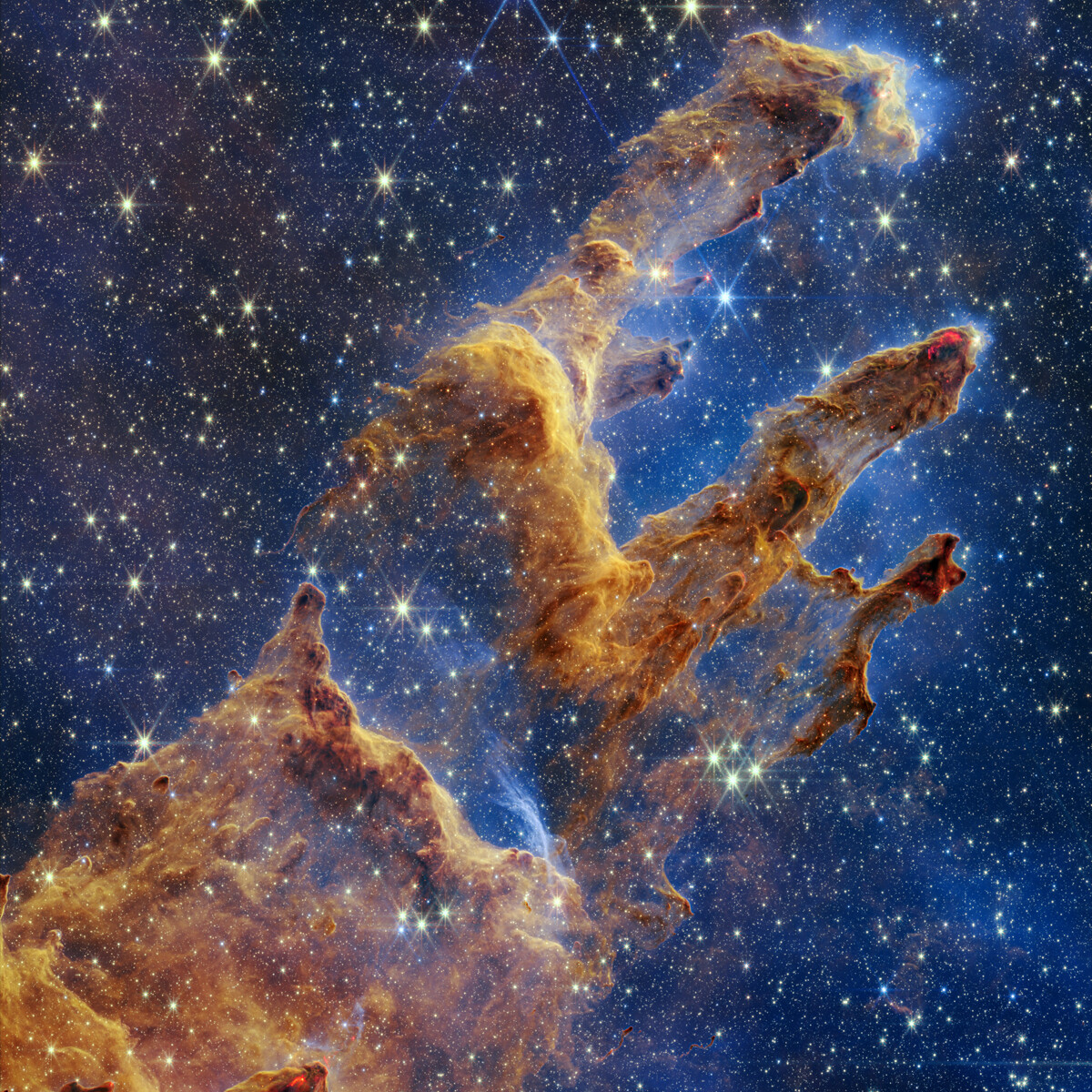 The Pillars of Creation in near-infrared light from the James Webb Space Telescope, translucent and star-filled